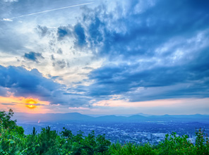 Photo of the sky, a city and the forest
